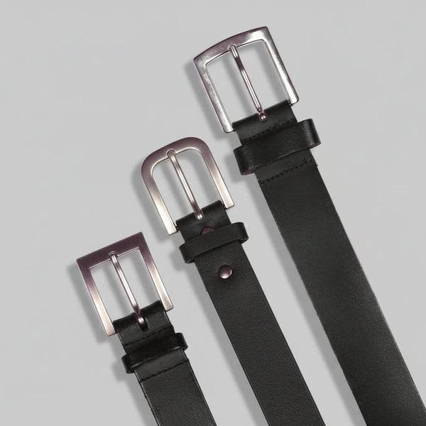 Three black belts with silver buckles on a white background